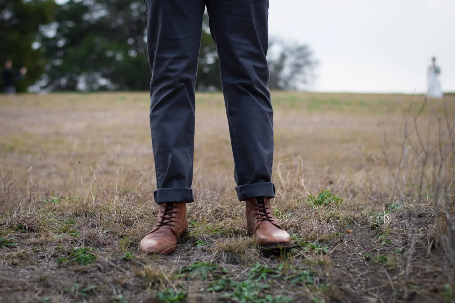 man standing in field with cuffed chinos