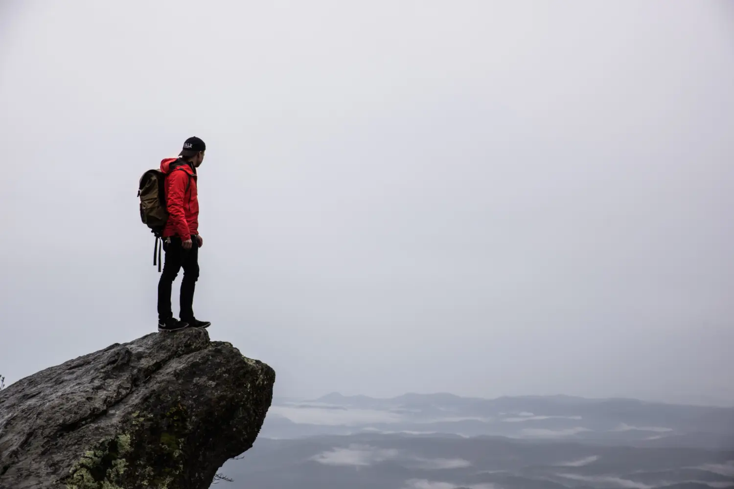 man standing on edge of cliff