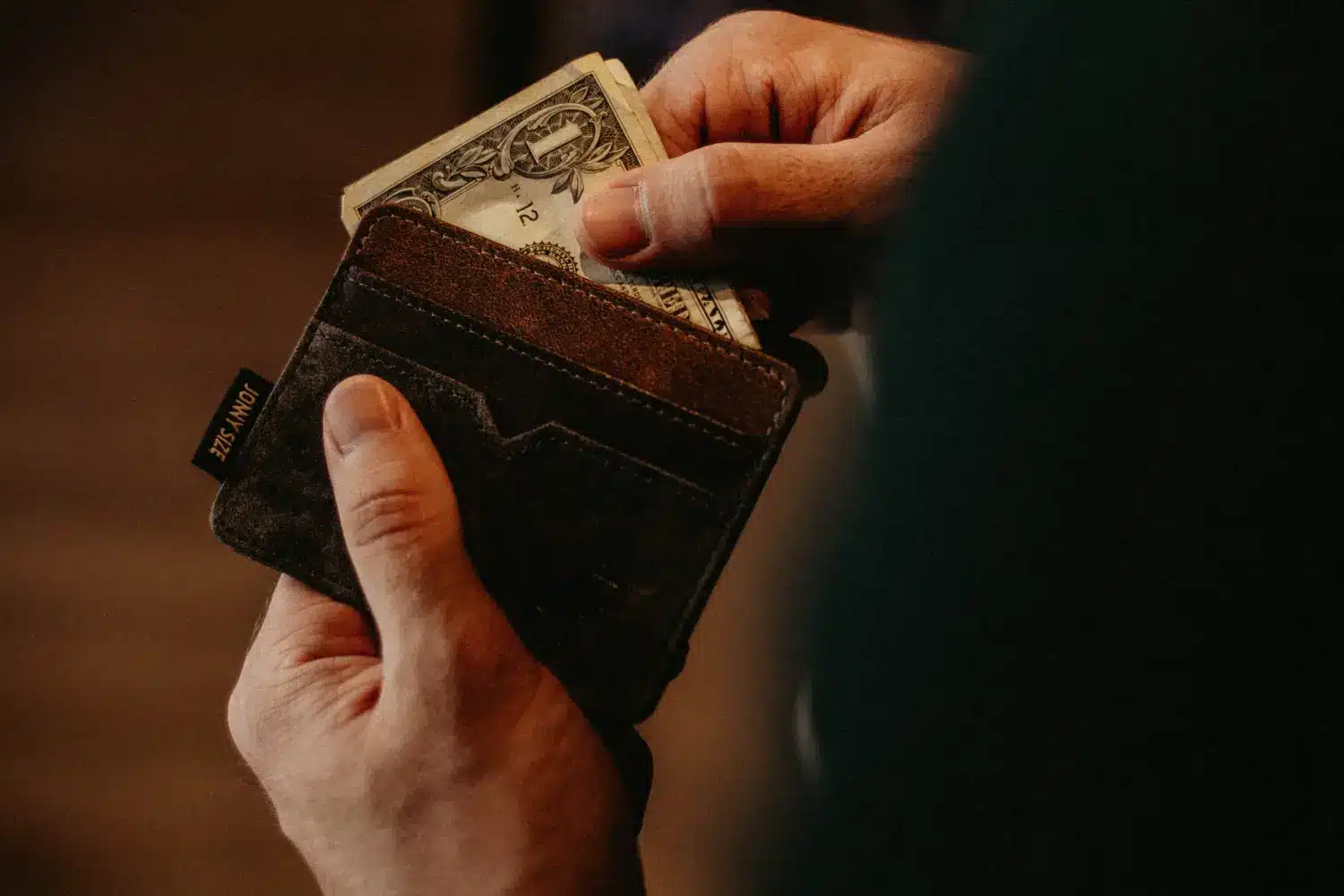 man taking dollars out of wallet