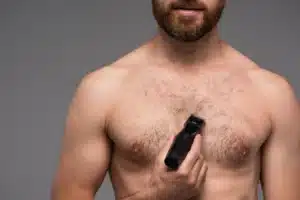 man trimming chest hair