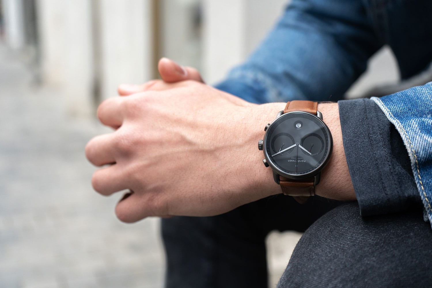 man wearing leather chronograph wrist watch