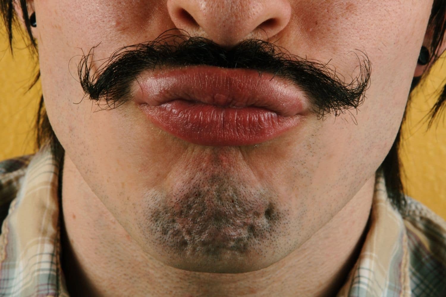 man with a mustache making kissing lips