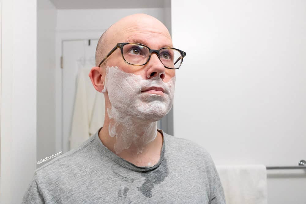 man with hand lather on face