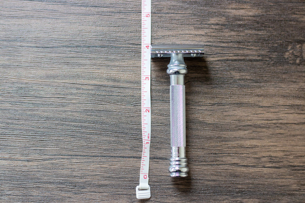 measuring tape next to merkur 38c on a brown table