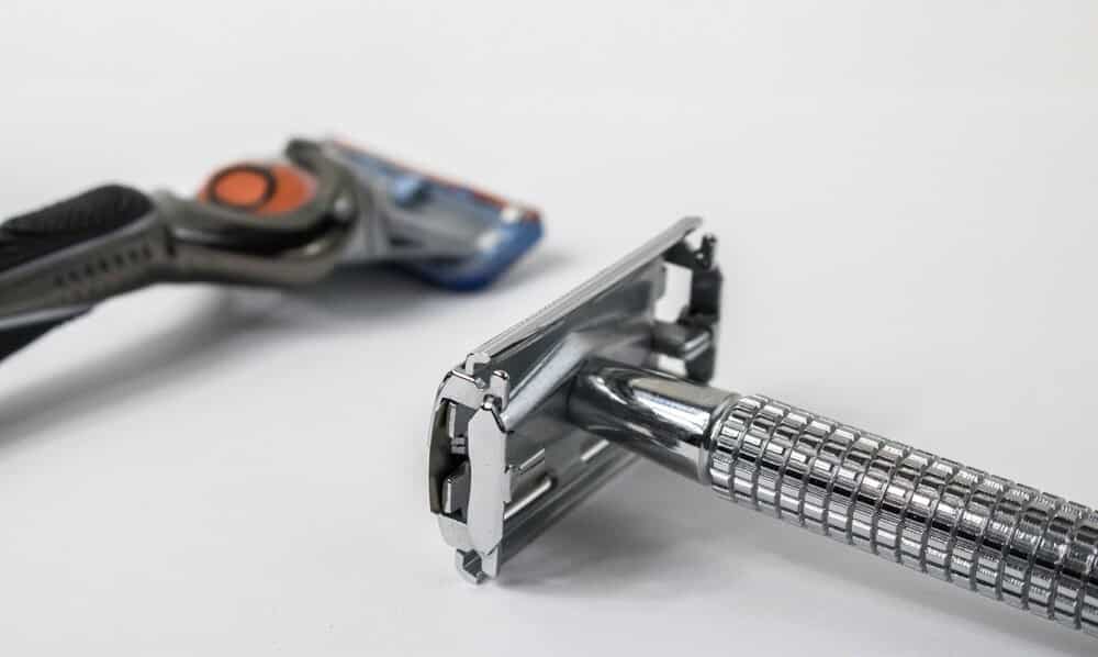 safety razor in foreground with cartridge razor in background