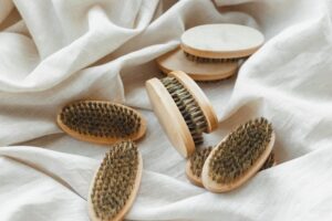 several of the same beard brushes on a white cloth