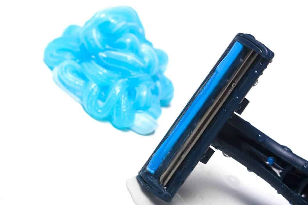 shave gel next to a cartridge razor
