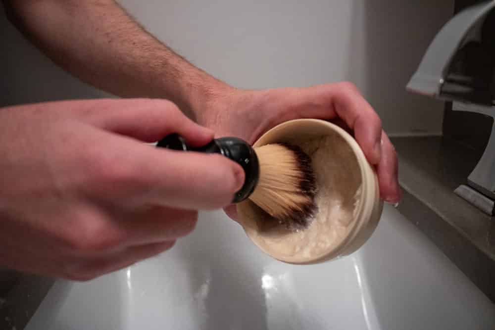 shaving brush being loaded with shaving cream