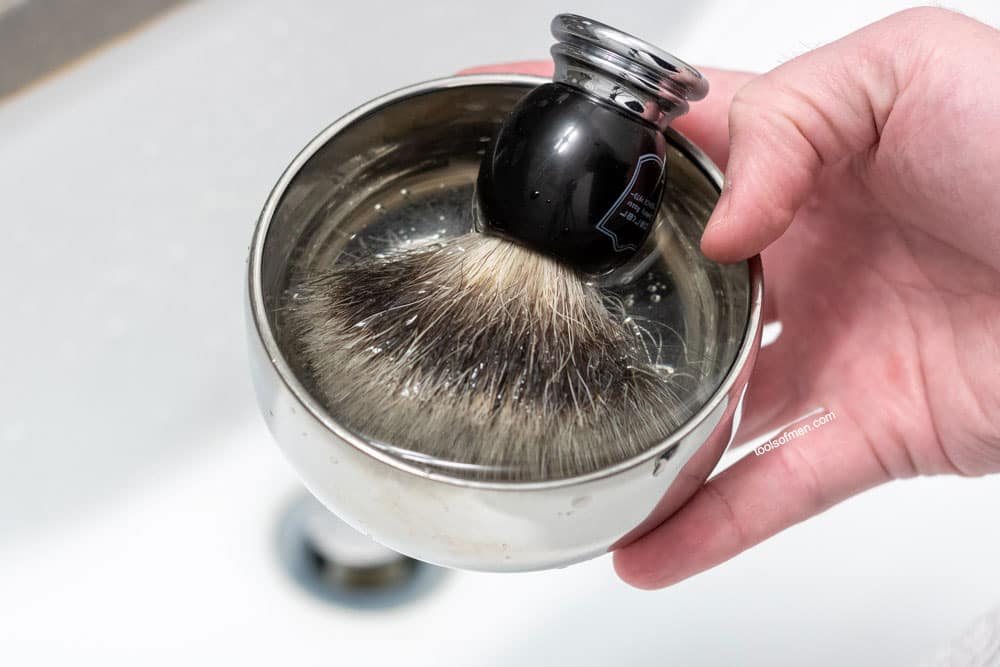 shaving brush blooming in bowl full of water