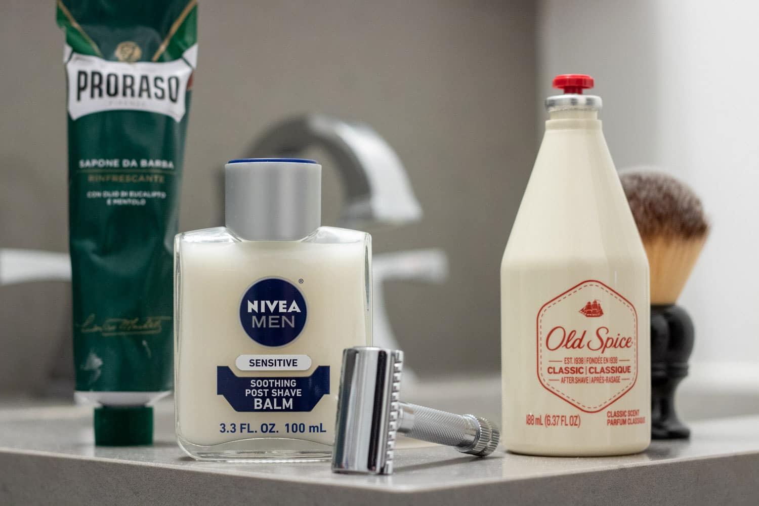 various aftershave products sitting on a bathroom countertop