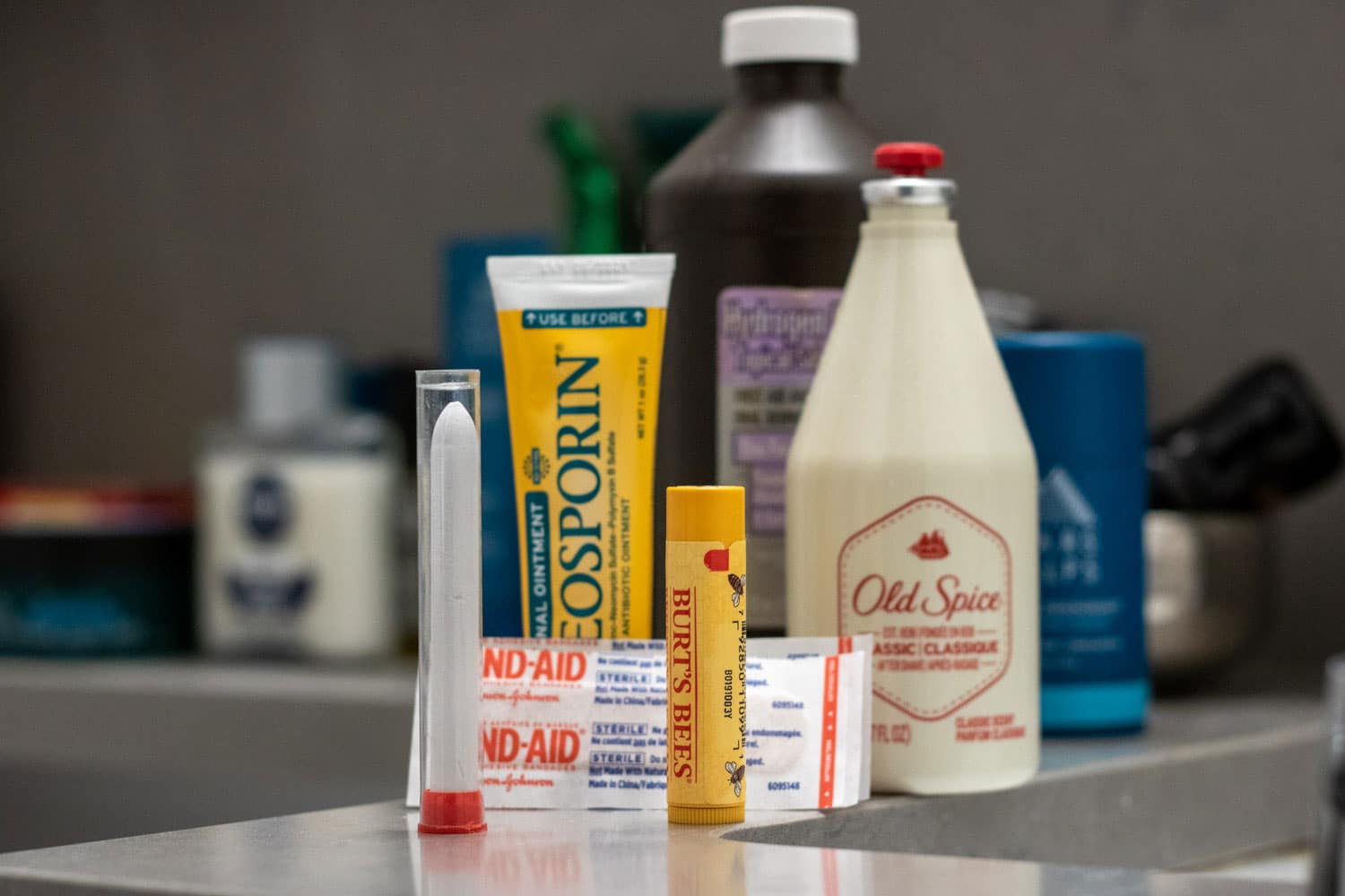 various products on bathroom countertop that help stop razor cuts