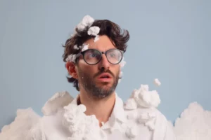man with cofused look and soap foam around him