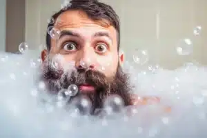 bearded man in bathtub full of bubbles