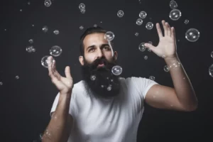 man with arms up and surrounded by bubbles
