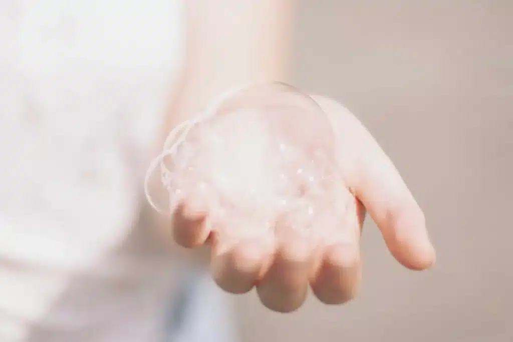 person holding soap bubbles in hand