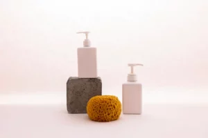 white dispeners on a table next to sponge