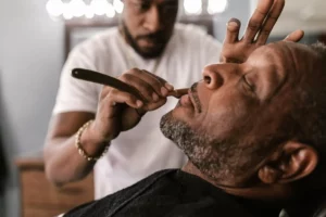 man getting a shave in a barbershop